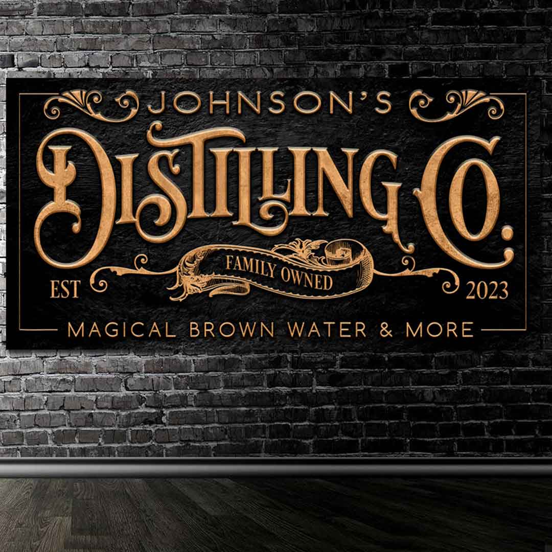 Bar signs distillery on black stone with gold letters.