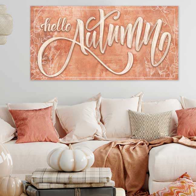 Hello Autumn Fall Wall Decor Sign in a tera cotta color with delicate leaves and big script letters.