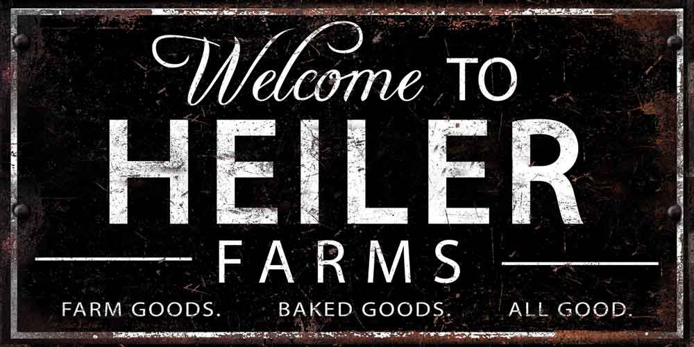 large metal sign personalized for farm or business with white lettering on black