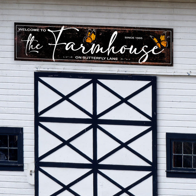 Large Barn Sign on distressed background with the words Welcome to the Farmhouse on butterlfy lane with butterflies on sign.