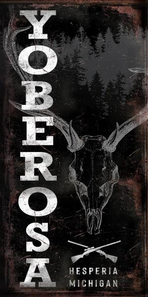 log cabin decor sign with rusty background pine trees and a deer skull and the cabin name