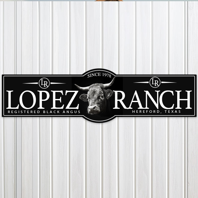 metal cattle ranch sign on black texture with white letters
