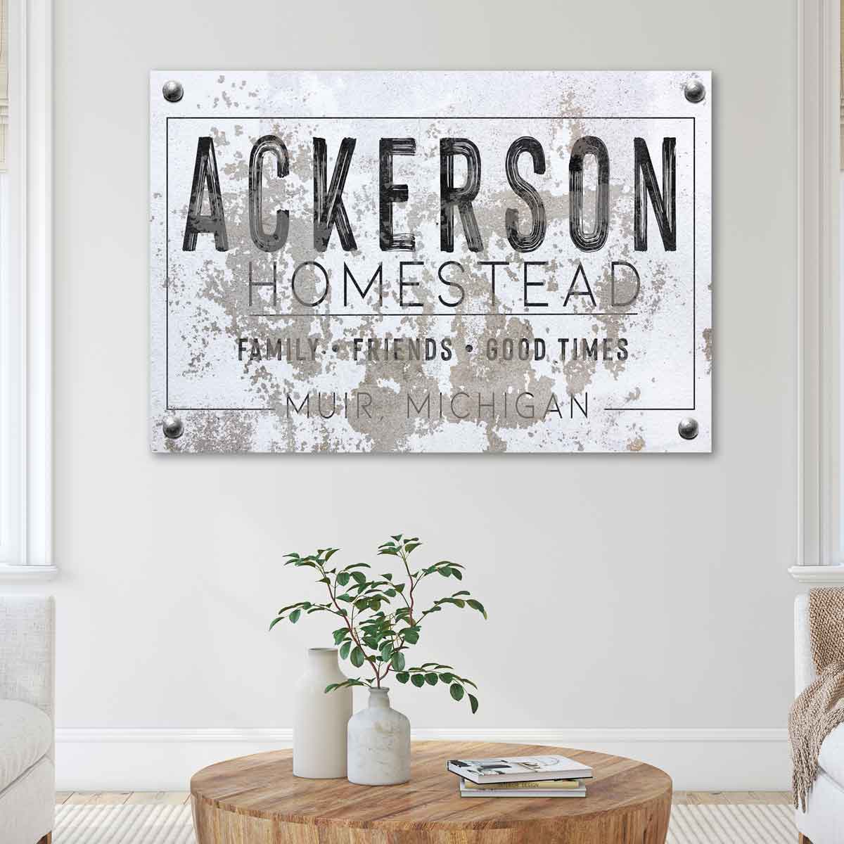 modern farmhouse wall decor sign on faux stone background: (family name) Homestead, family, friends, good times.