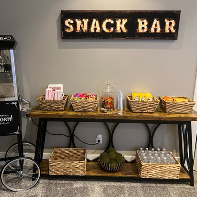 Theater room decor snack bar sign on black distressed background with the words Snack Bar in faux marquee lights