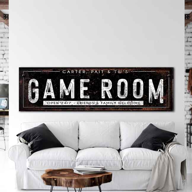 Gaming Room Decor of a big black sign that says: Game Room, open 24/7, Friends and family welcome, Personalized with family names.