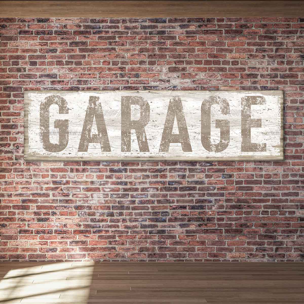Reads Garage in light brown on canvas or metal with a background that appears to be white wood