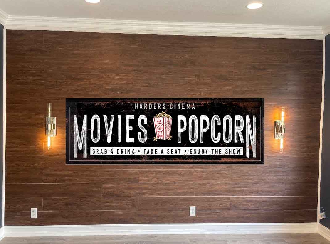 Movie Room Decor on brown wood wall with 2 sconces on the side.