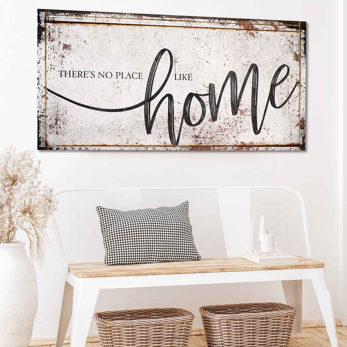 Modern farmhouse wall decor of distressed wood and the words: There's no place like Home
