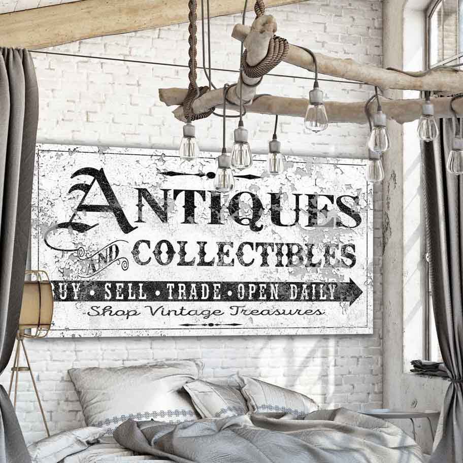 Antiques Sign [Antiques and Collectibles - Buy, sell, trade, open daily, shop vintage treasures] on vintage white distressed wood. Large White canvas on brick wall with a French Country Farmhouse style room