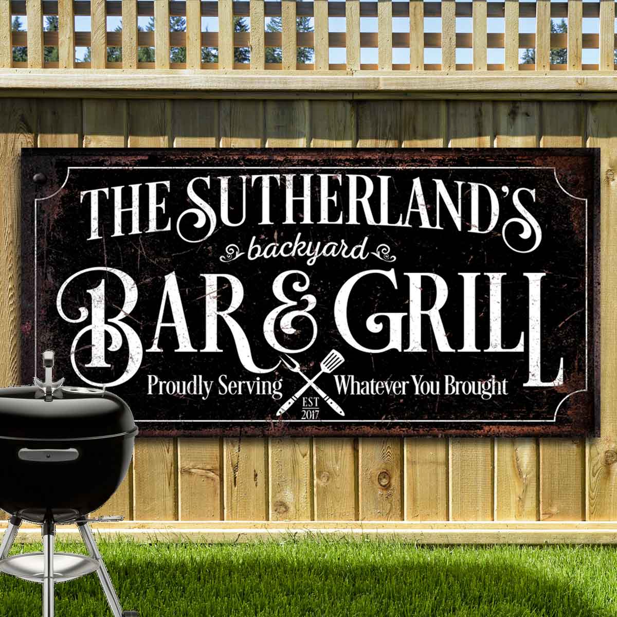 Backyard Metal Signs Posted on wood fence with words: The sutherland's backyard Bar and Grill, proudly serving whatever you brought