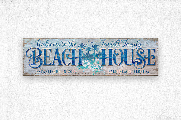 metal beach house sign with blue text and flowers