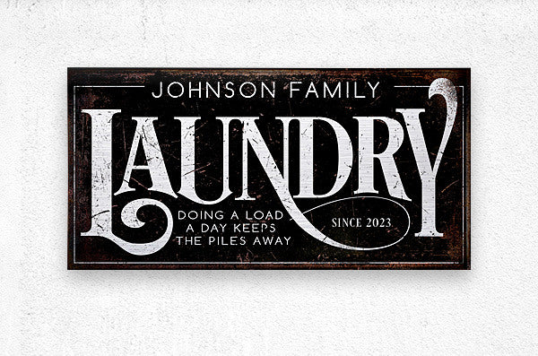 metal laundry room sign in metal on black distressed background with white words