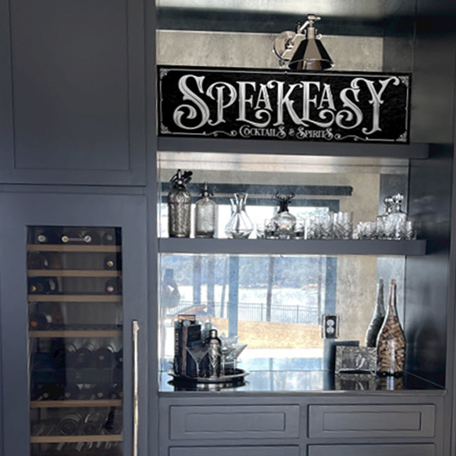 speakeasy decor silver and black on a bar shelf