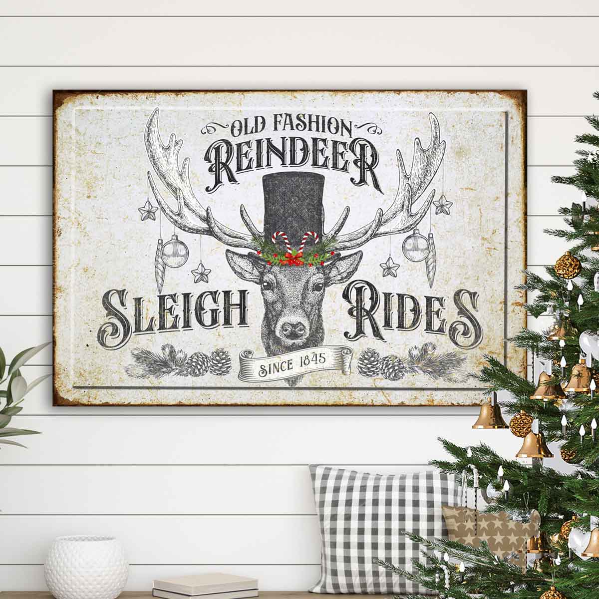 Vintage Christmas Decor of a black and white deer with a top hat and ornaments hanging from his antlers with words: Old fashion reindeer sleigh rides.