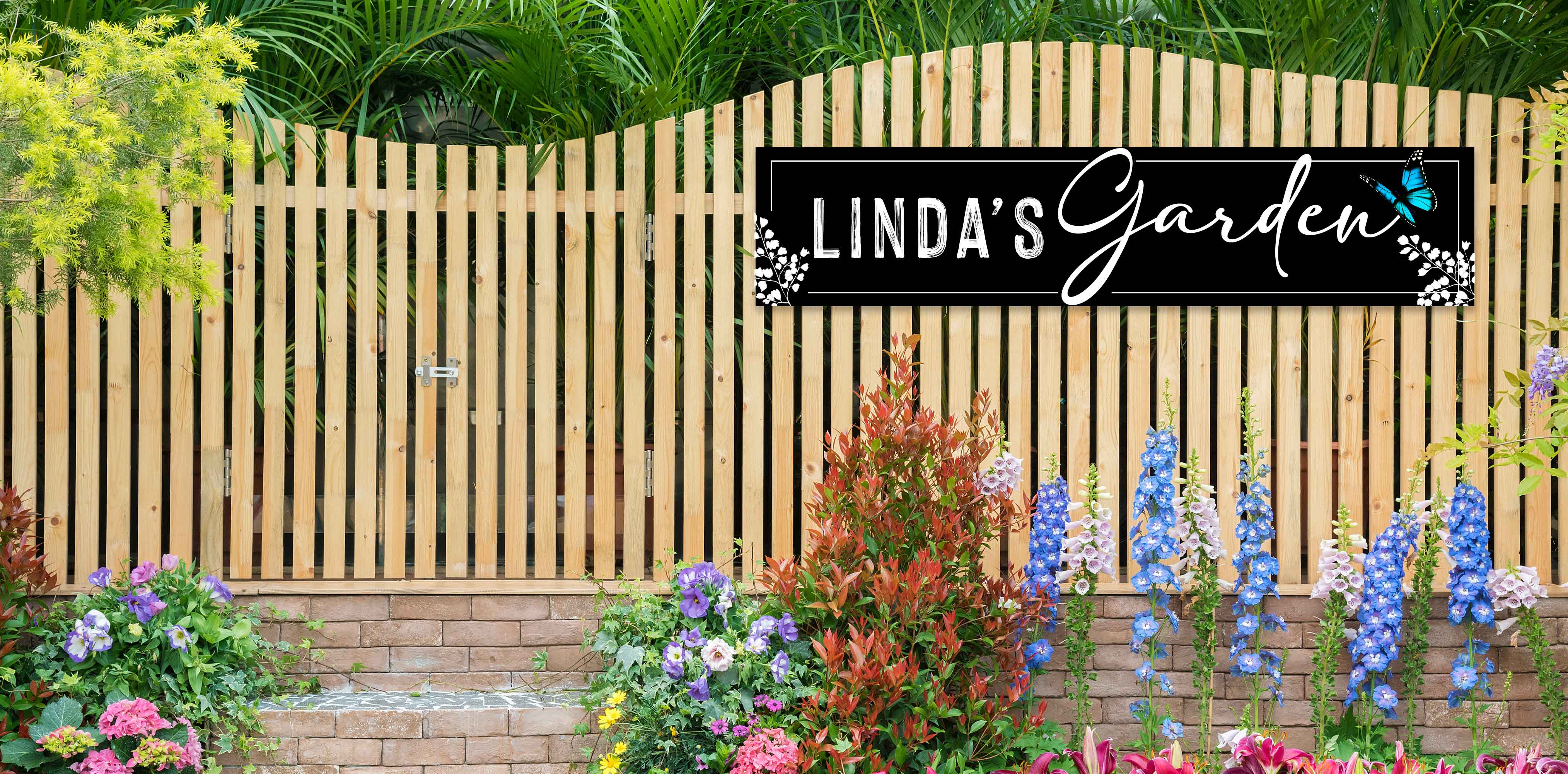garden signs personalized on a wooden fence in a flower garden