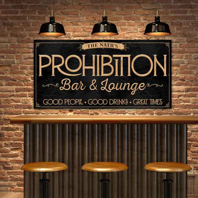 Personalized prohibition wall art with family name. Black metal or canvas sign with ornate modern gold font. Sign reads "Prohibition bar & lounge. Good people. Good drinks. Great times." 