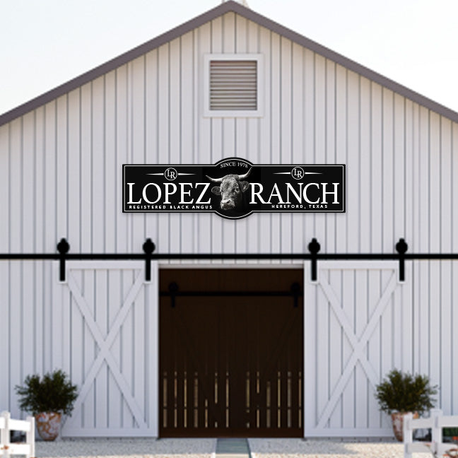 Large metal signs for a cattle ranch with a angus bull and the family name and ranch name