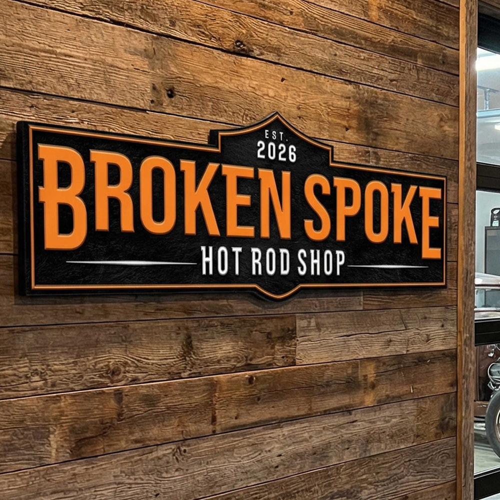 aluminum business sign on a wooden wall entrance to a business car shop