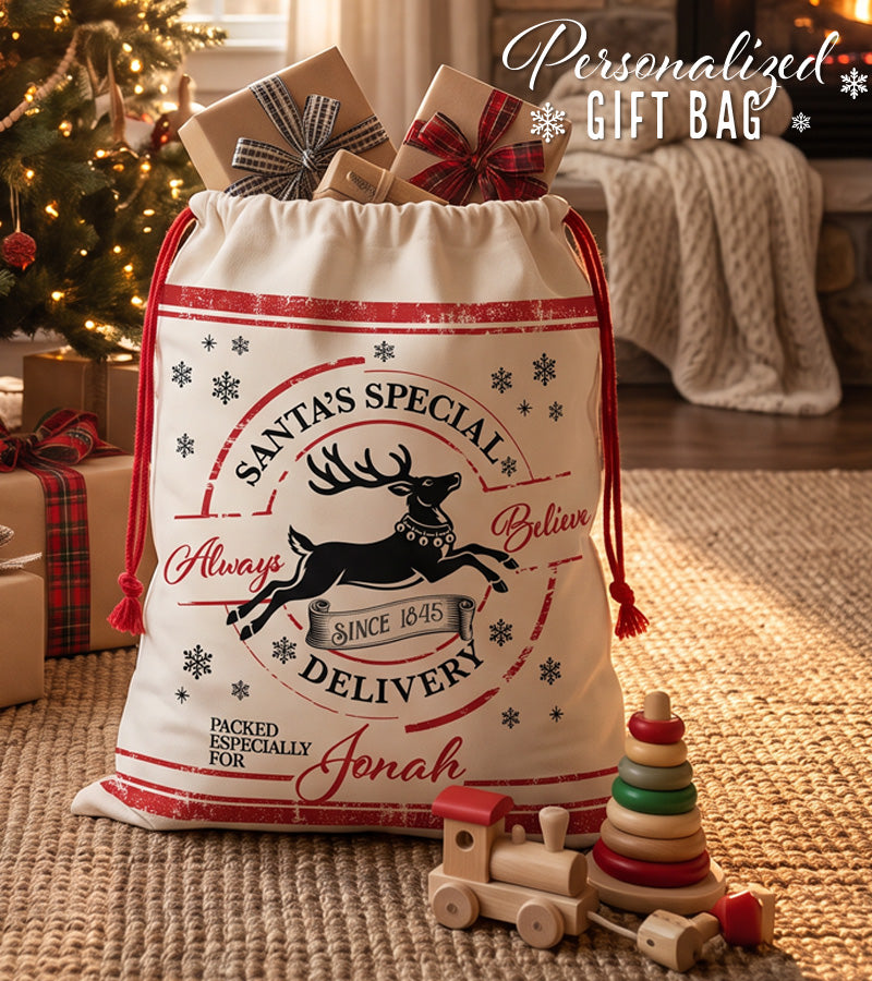 Personalized Santa sack with a leaping reindeer and the words Always Believe, beside a Christmas tree