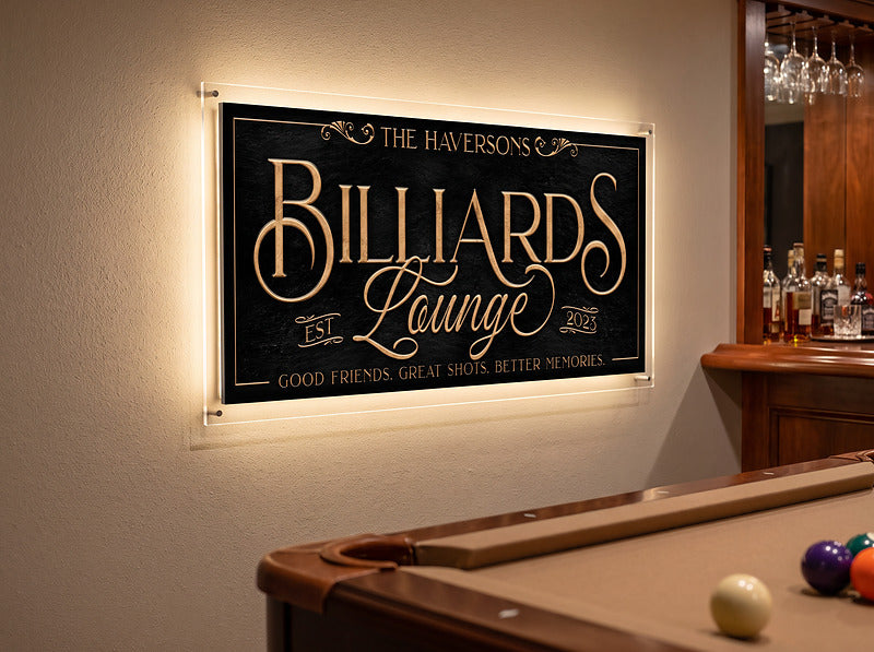 Backlit billiards sign glowing from an LED strip the owner fitted, hung above a pool table beside a home bar, lighting not included