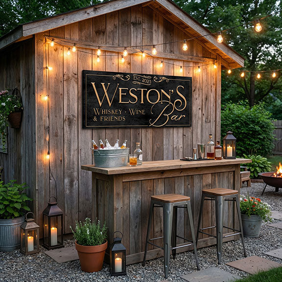 Wooden outdoor bar with 'Weston's Whiskey & Wine & Friends' bar decor sign, surrounded by string lights and lanterns.