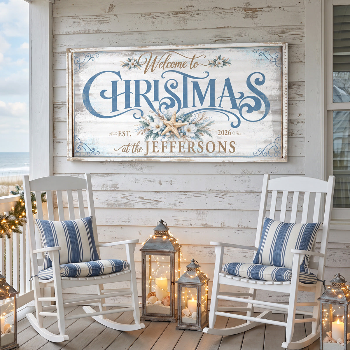 Personalized beach Christmas sign on a porch wall above white rocking chairs with the ocean behind
