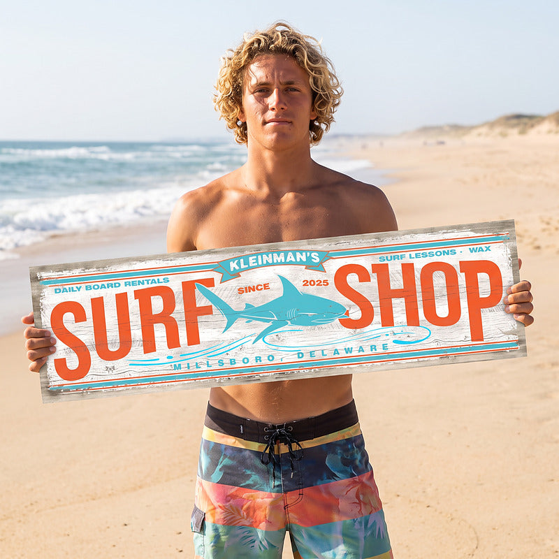 Beach signs surf decor held by a surfer on the sand, showing the long narrow shape and size