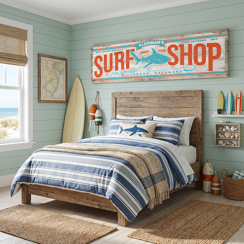 Beachy decor surf sign hung over a bed in a mint green coastal bedroom with a surfboard leaning by the window