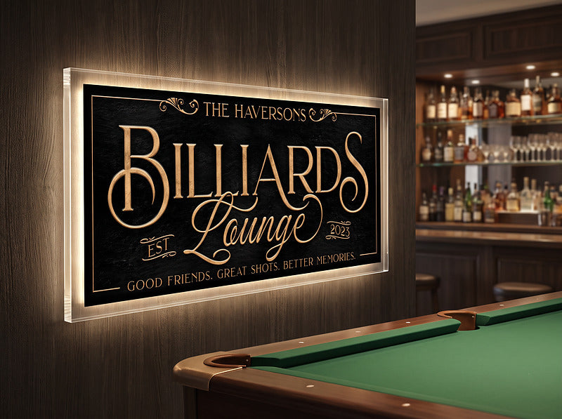 Billiard decor sign on a dark wall above a pool table in a basement bar with bottle shelving behind