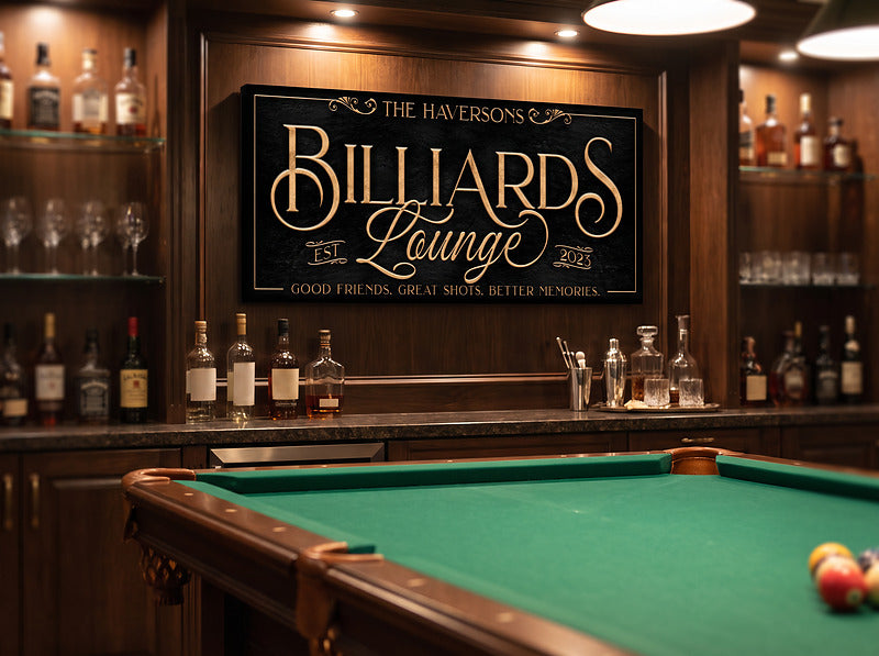 Billiards bar sign mounted in a back bar between whiskey bottles and glassware, above a green felt pool table in a home billiards lounge
