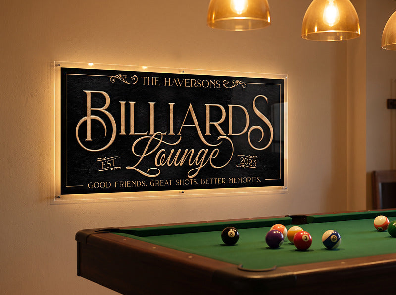 Personalized billiards sign reading The Haversons Billiards Lounge Est 2023, hung above a pool table in a home billiards room, shown with customer added LED backlighting
