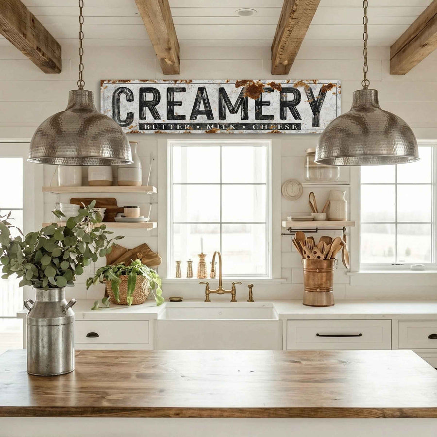 canvas farmhouse decor in a Kitchen with wooden beams, hanging lights, and a 'Creamery' sign.