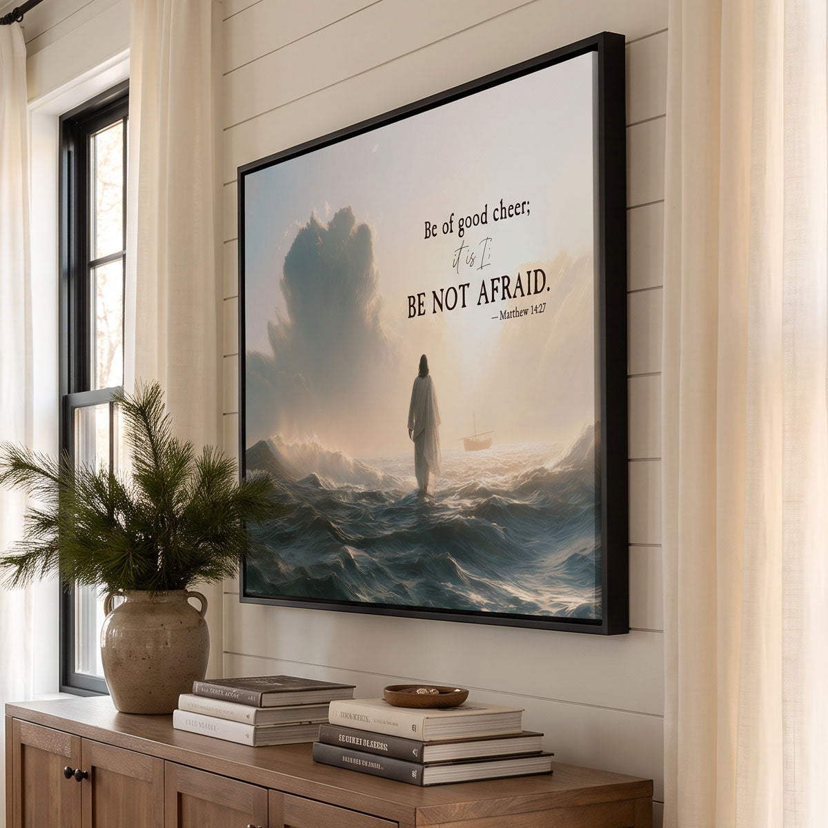 Be Not Afraid framed canvas in black above an oak console in a sunlit entry with cream curtains and pine in a stone vase