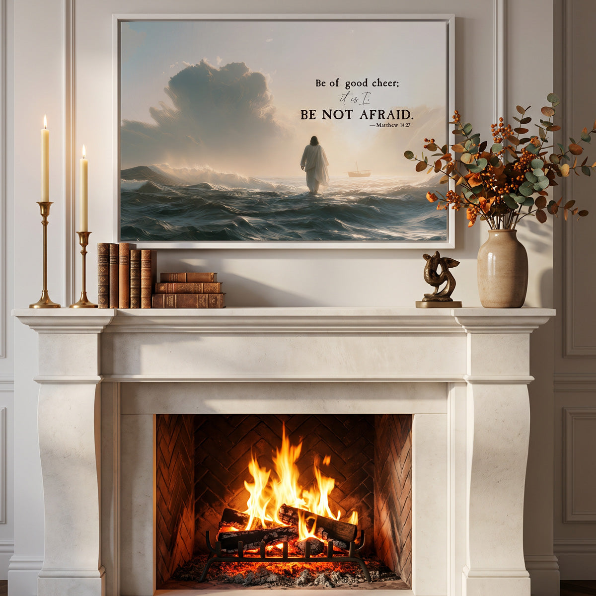 Be Not Afraid scripture canvas in a white frame above a lit limestone fireplace with brass candlesticks, antique books and autumn berries