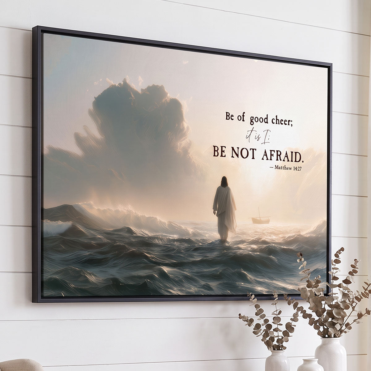 Close angled view of the black floater frame on the Be Not Afraid canvas against white shiplap, showing the frame depth