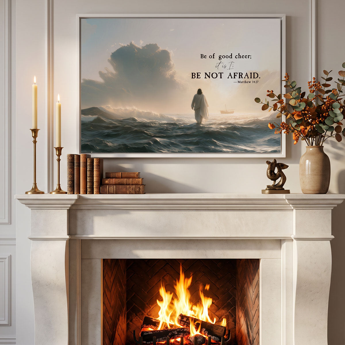 Matthew 14:27 bible verse wall art in a white frame centered above a lit fireplace, close view of the mantel styling