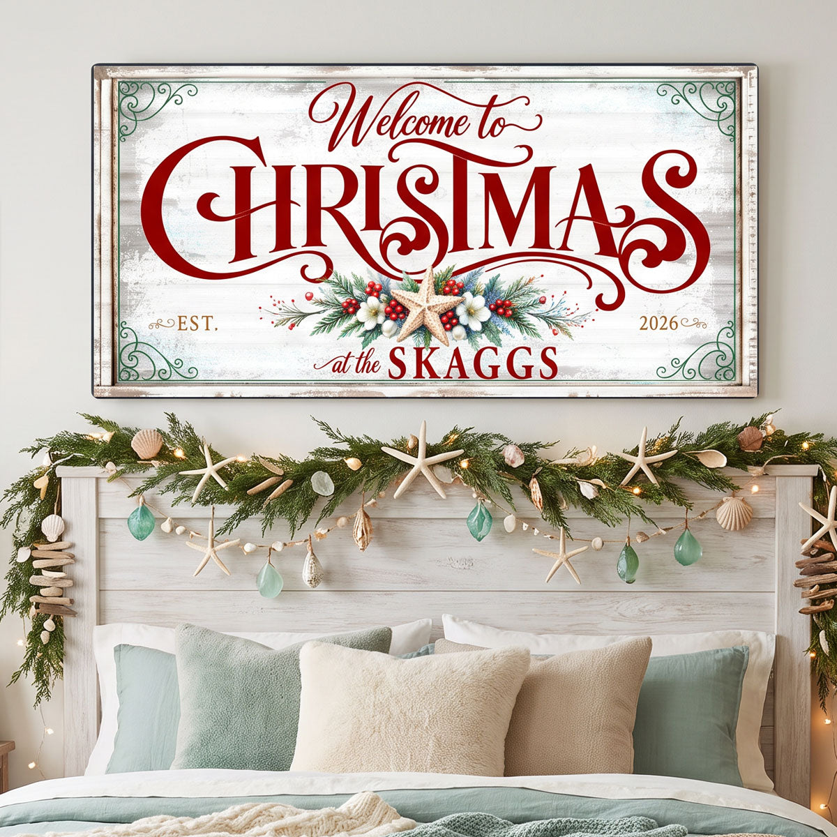 Personalized Christmas sign hung above a bed with a garland of starfish and sea glass
