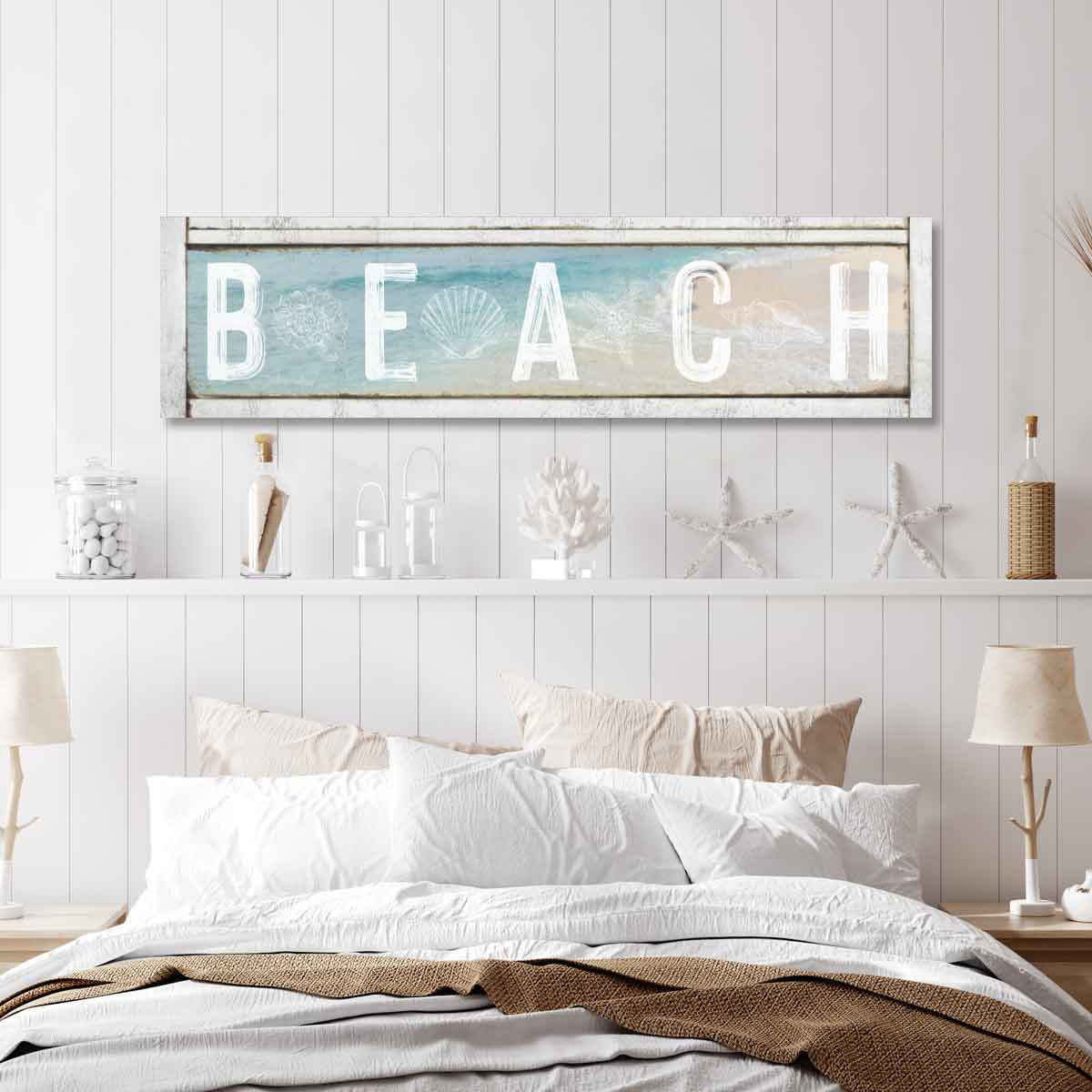 Coastal Decor Beach house Sign on faux wood frame with the words [beach] with blue beach water and sand in background with shells between letters.