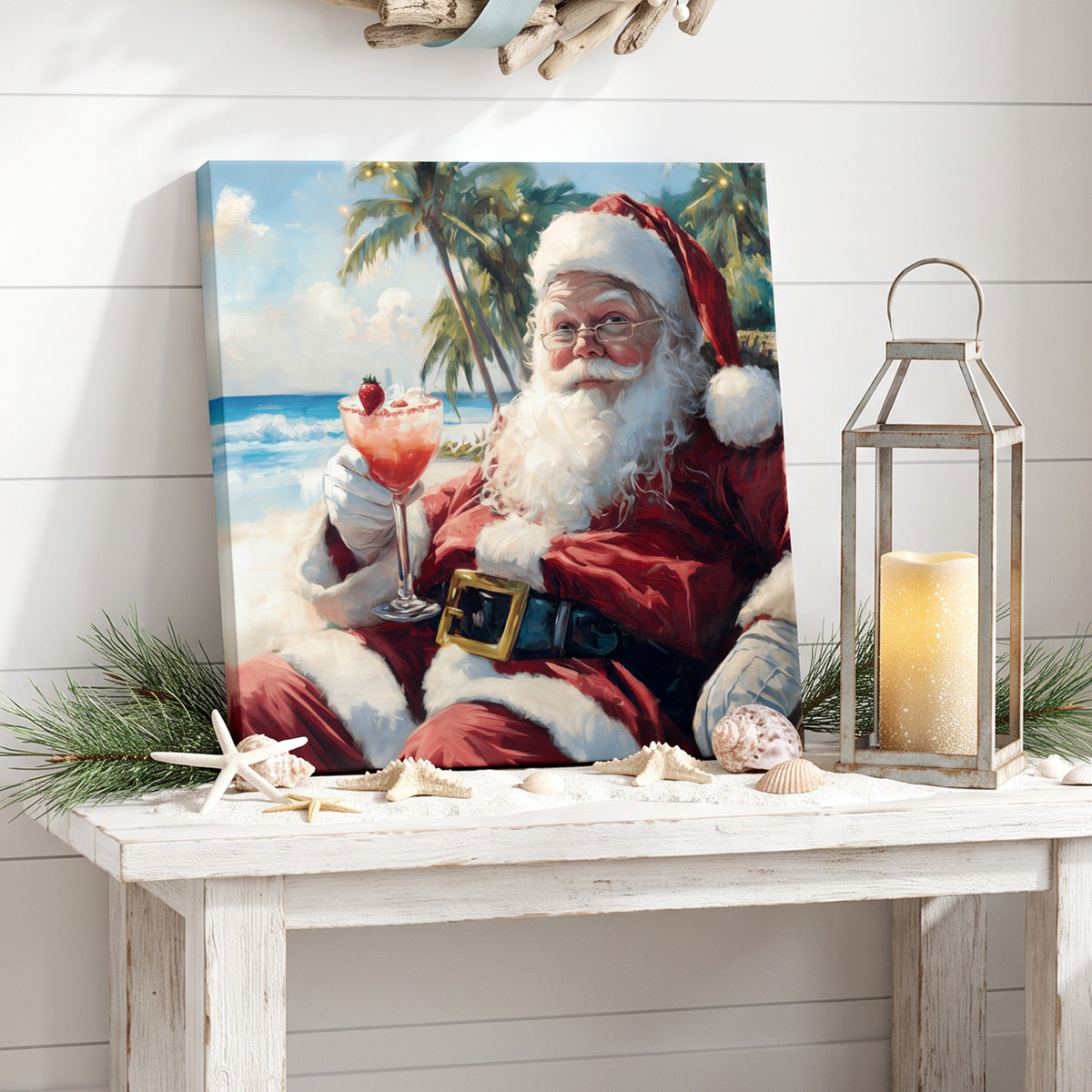 Coastal Christmas wall art canvas of a tropical Santa with a cocktail, on a console with a lantern and starfish