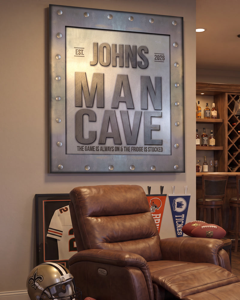 Custom man cave sign above a leather recliner in a finished basement game room with a home bar