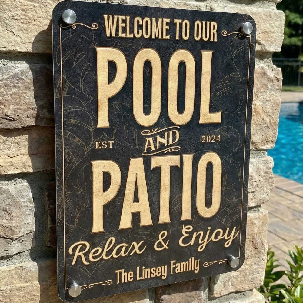 Decorative custom pool and patio sign welcoming to pool and patio with stone wall and pool background