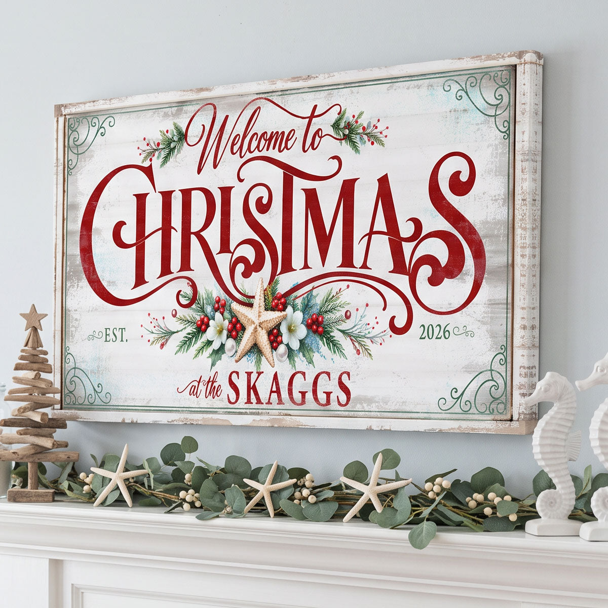 Personalized farmhouse Christmas sign on a pale blue wall above a mantel with eucalyptus and starfish