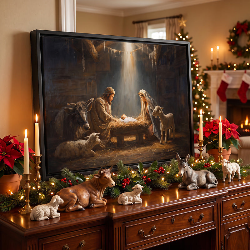 Nativity scene canvas in a black frame on a wood sideboard with lit garland, brass candles and a nativity figurine set