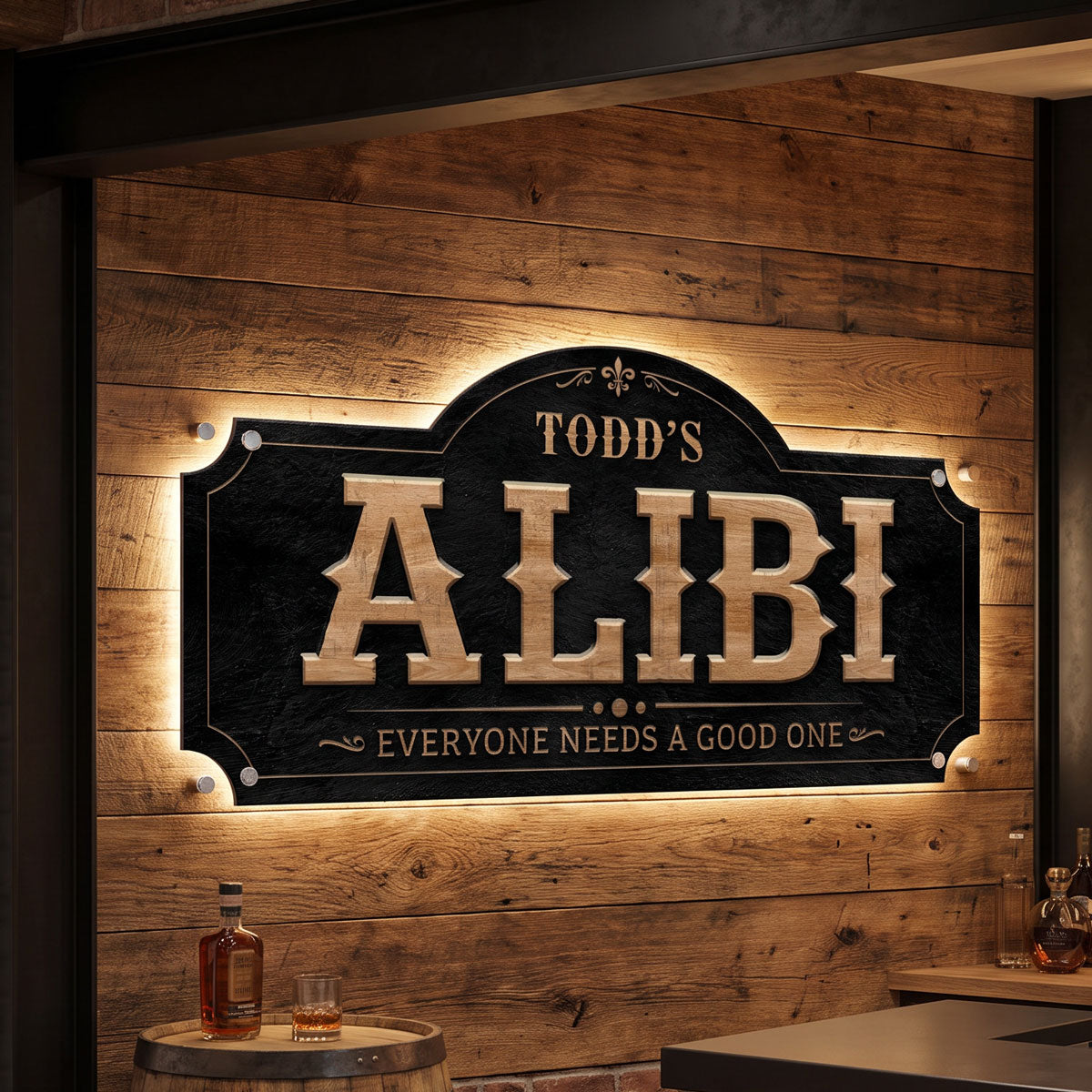 Funny bar sign Todd's Alibi with LED backlighting on a barnwood wall above a whiskey barrel table in a home bar