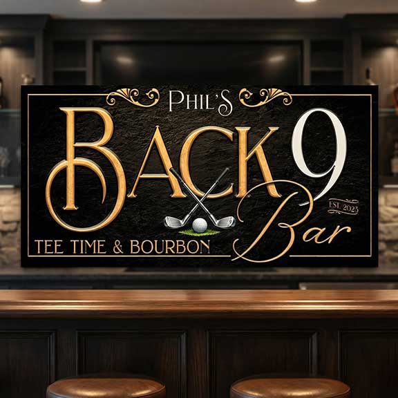 Decorative golf wall art sign for 'Phil's Back 9 Bar' with golf-themed design on a bar counter.