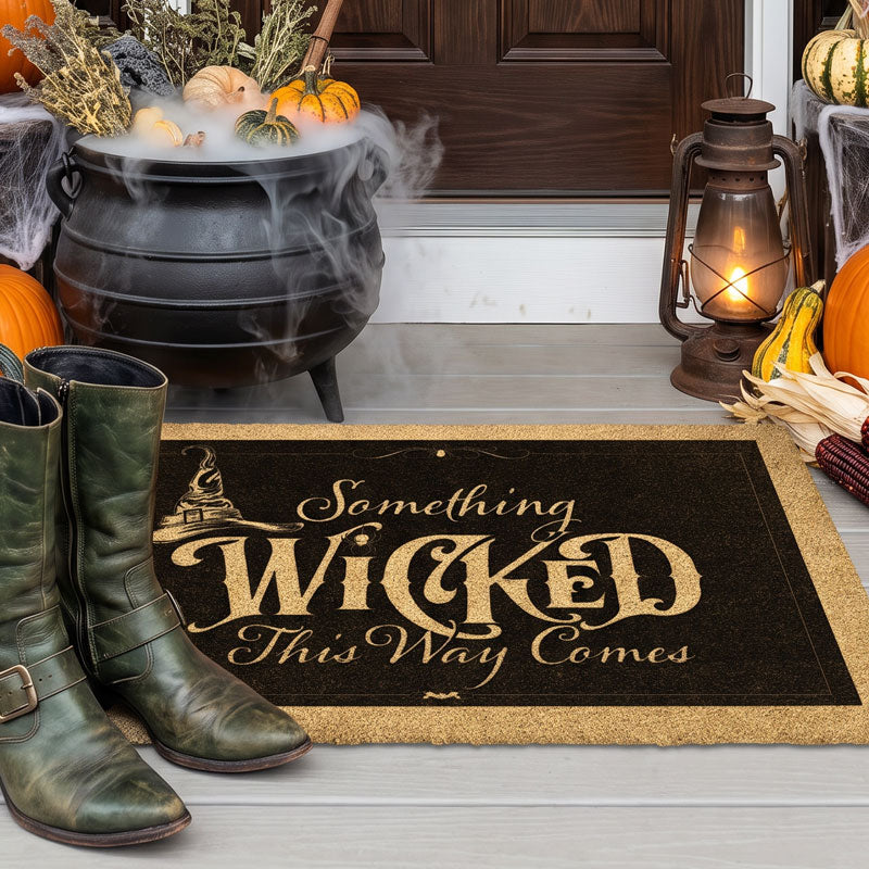 Halloween witch doormat reading Something Wicked beside a smoking cauldron and a lit lantern