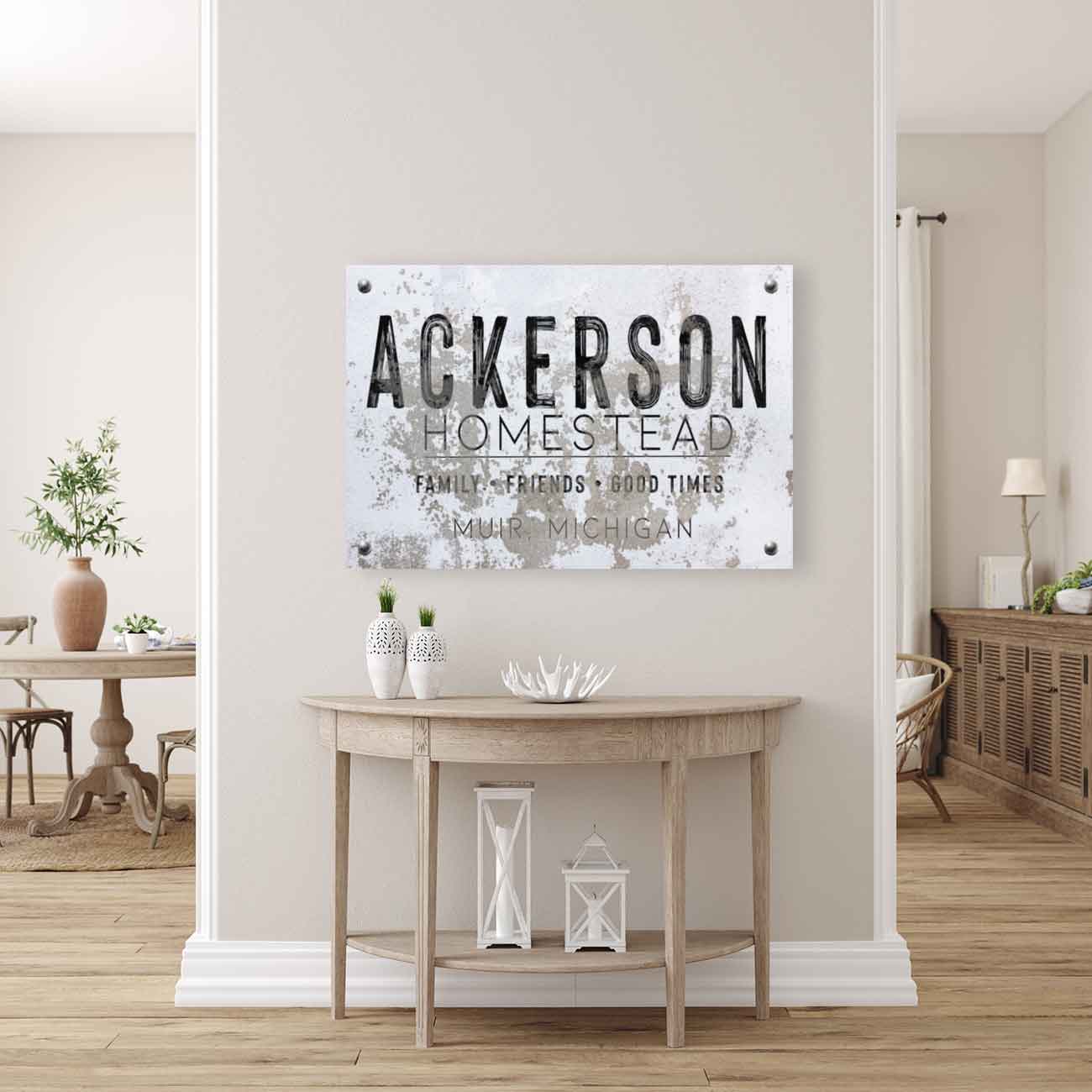 industrial farmhouse wall decor sign on faux stone background: (family name) Homestead, family, friends, good times.