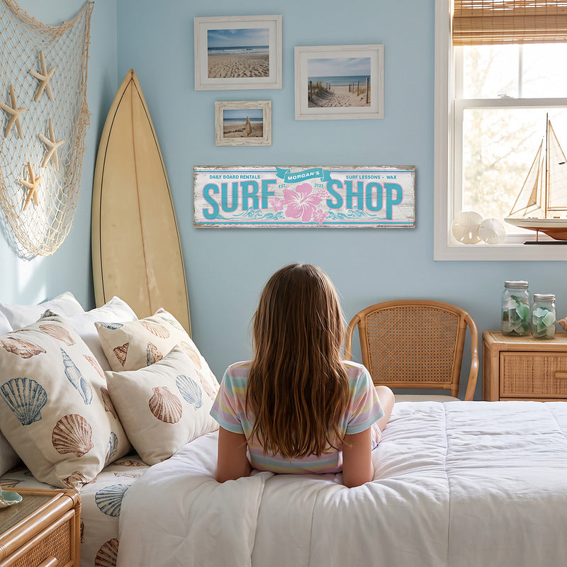 Kids surf wall art on a girls bedroom wall above the bed, with a surfboard and shell pillows