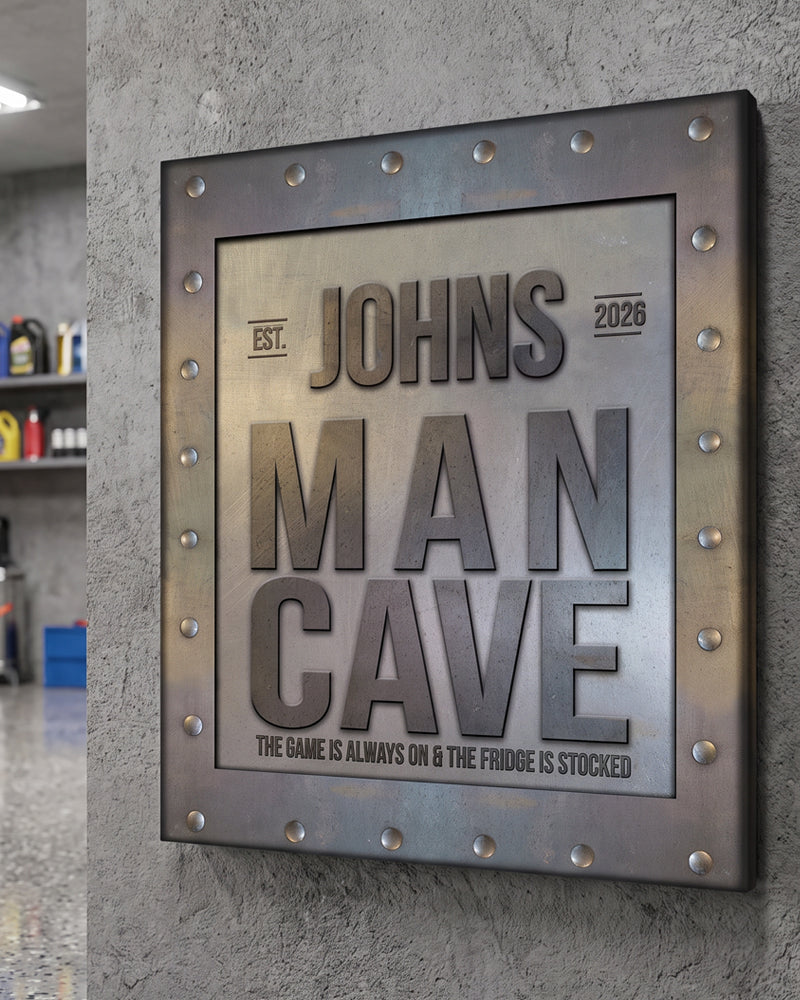 Man cave sign with the game is always on tagline, riveted metal-look art on a concrete garage wall