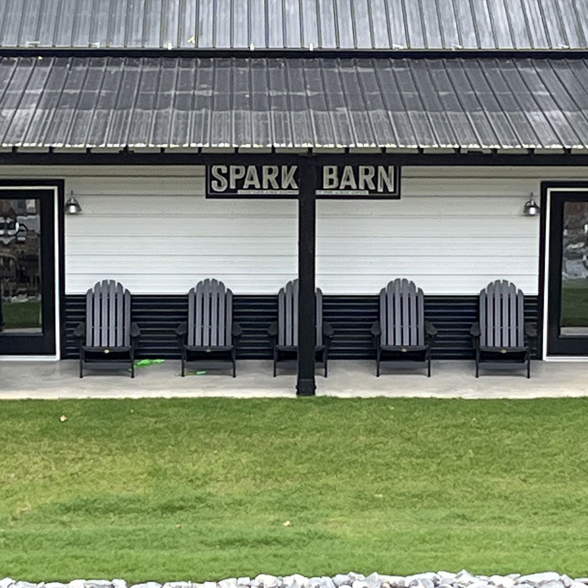 metal barn signs in black and white on the side of a modern barn.